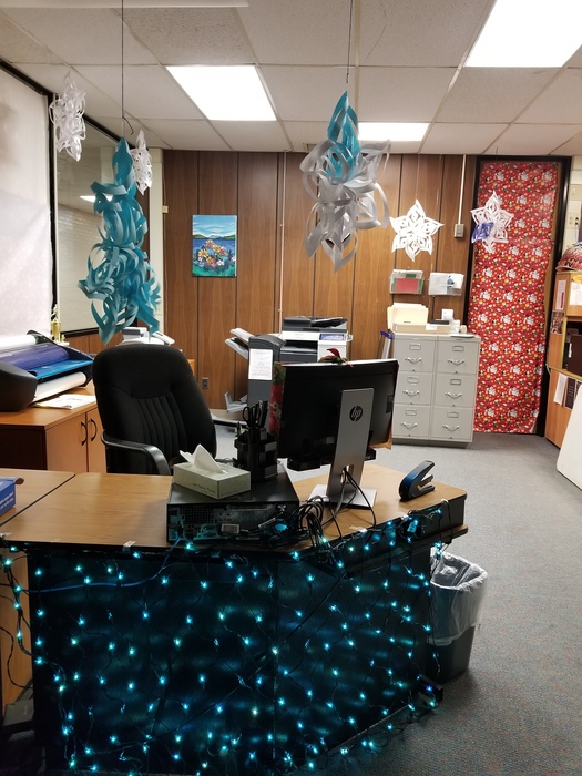 Snowflakes and lights decorate the desk